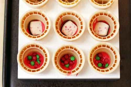 adding candy to cupcake ice cream cones