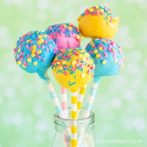 Blue, yellow, and pink cake pops covered in sprinkles