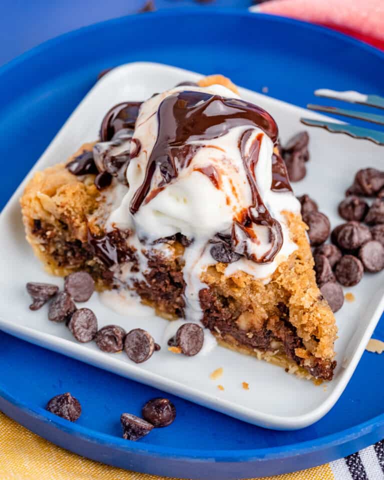 A photo of chocolate chip cookie pie on a blue plate.