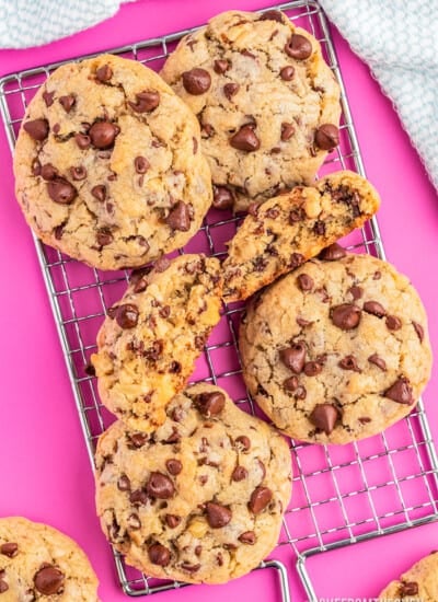 photos of levain chocolate chip cookies on a pink background