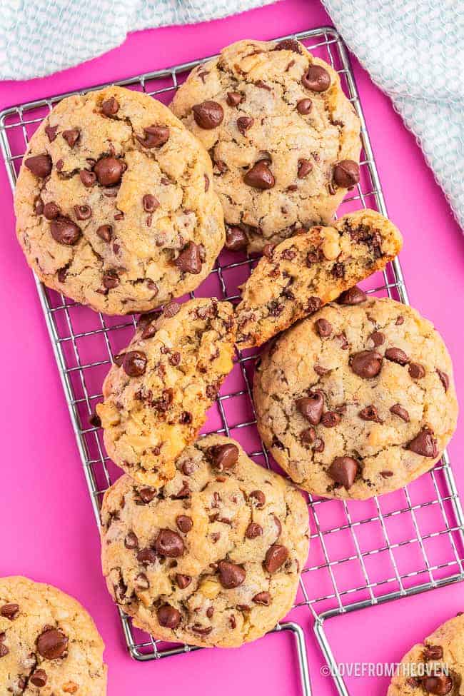 photos of levain chocolate chip cookies on a pink background