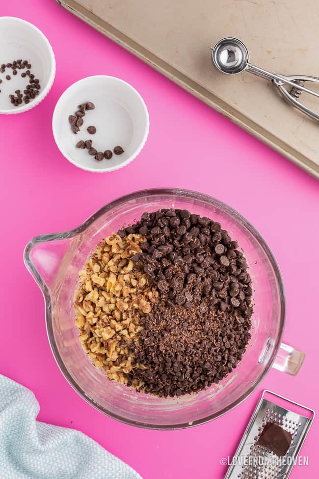 A bowl of cookie dough on a pink background