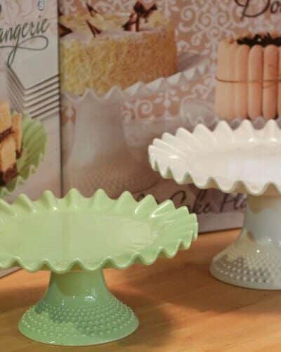 A green cake stand and a white cake stand