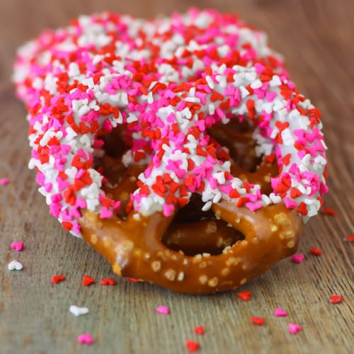 pretzels with dipped frosting and valentines sprinkles