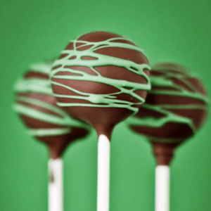 thin mint pops on white sticks in front of a green background