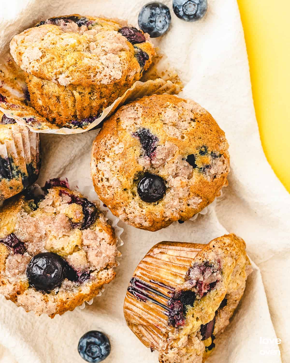 Multiple blueberry banana muffins on a fabric napkin. 