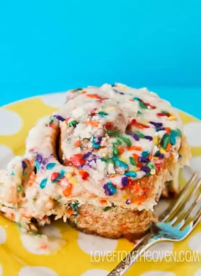 A cinnamon roll with sprinkles on top.