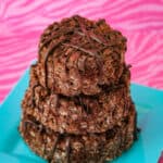Chocolate rice krispie treats on a blue plate on a pink background.