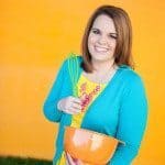 Christi, author of Love From The Oven, holding a mixing bowl and smiling.