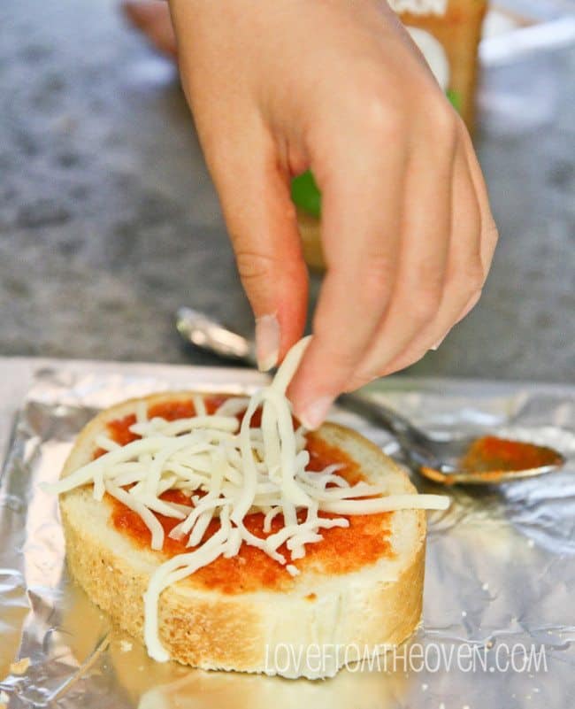 A close up of a person holding a piece of food, with Pizza and Bread