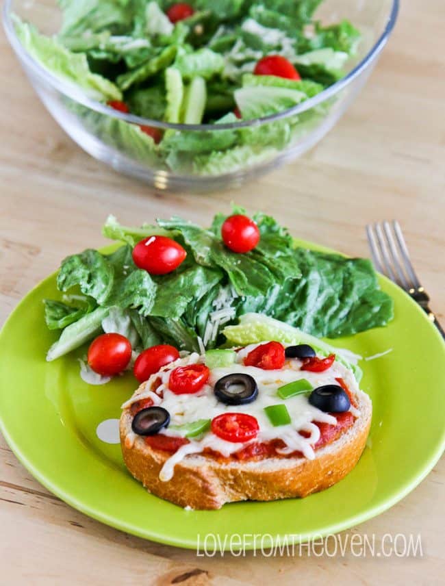 A salad on a plate, with Pizza and Bread