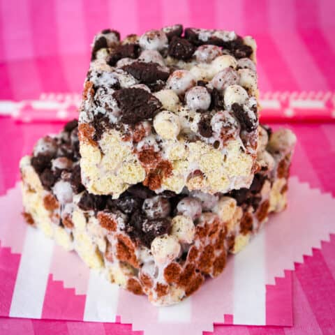 Cookies and Cream bars on a pink background.