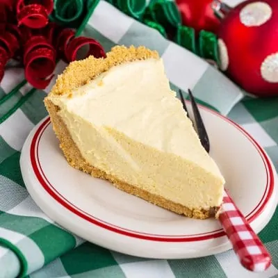 A slice of eggnog pie on a colorful background.