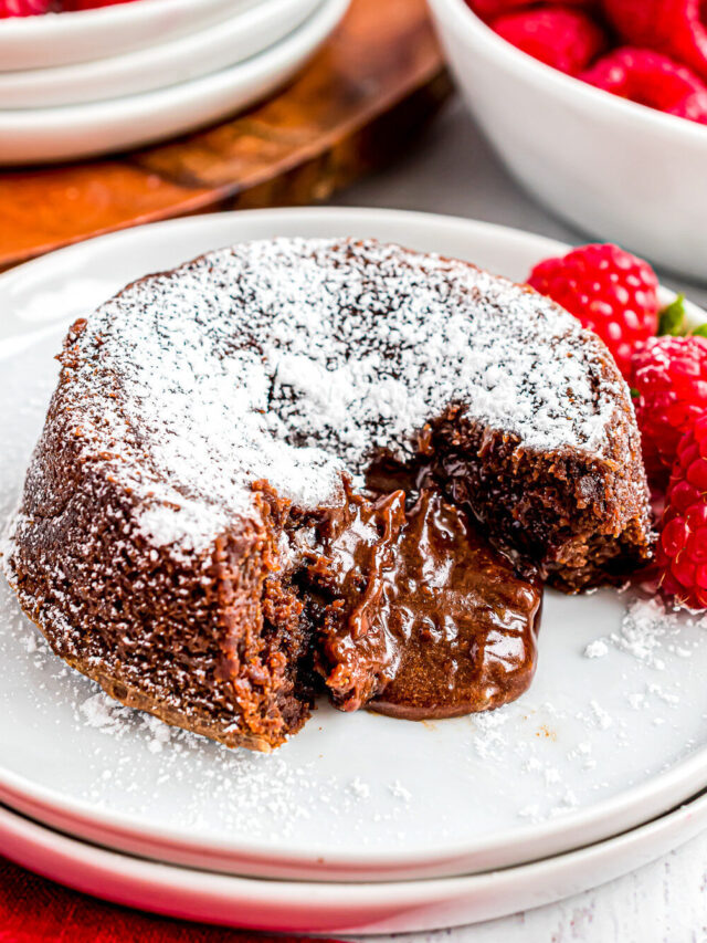 A molten chocolate lava cake with raspberries