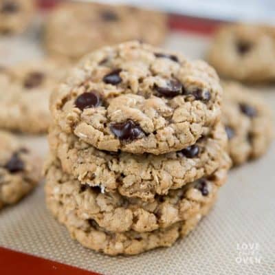 Stack of chewy oatmeal cookies on a baking tray