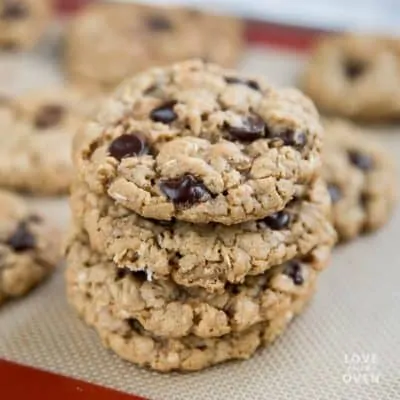 Stack of chewy oatmeal cookies on a baking tray