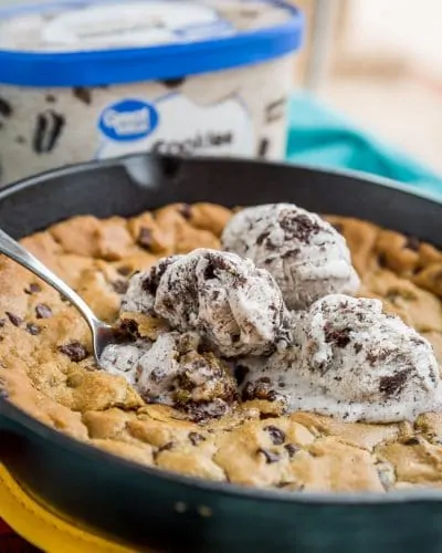 Giant cookie in a skillet topped with ice cream