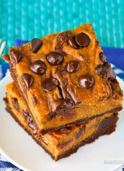 pumpkin brownies on a white plate with a blue background