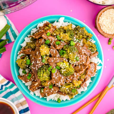 beef and broccoli on a turquoise blue plate