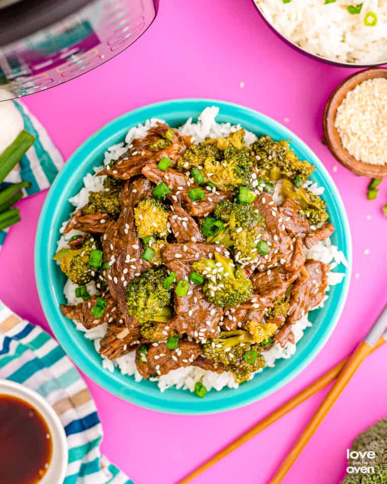 beef and broccoli on a turquoise blue plate