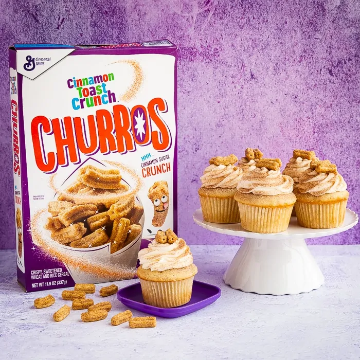 A box of Cinnamon Toast Crunch Churros Cereal with churro cupcakes