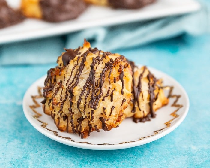 Two coconut macaroons with chocolate drizzled over tops