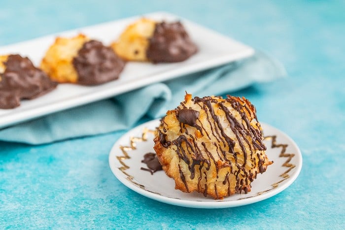 Coconut macaroon cookies drizzled with chocolate on plate