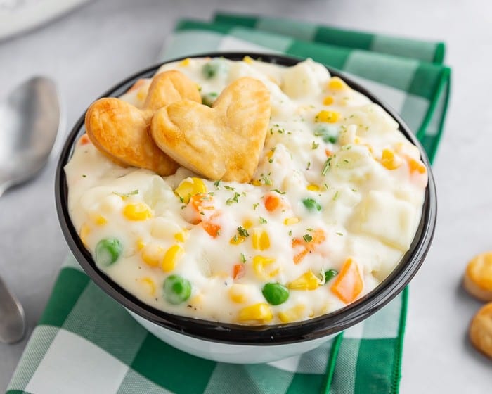 Pot pie soup in a bowl with heart shaped crackers