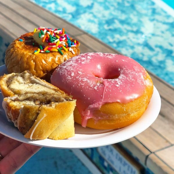 Plate full of pastries including a donut, bread and french toast