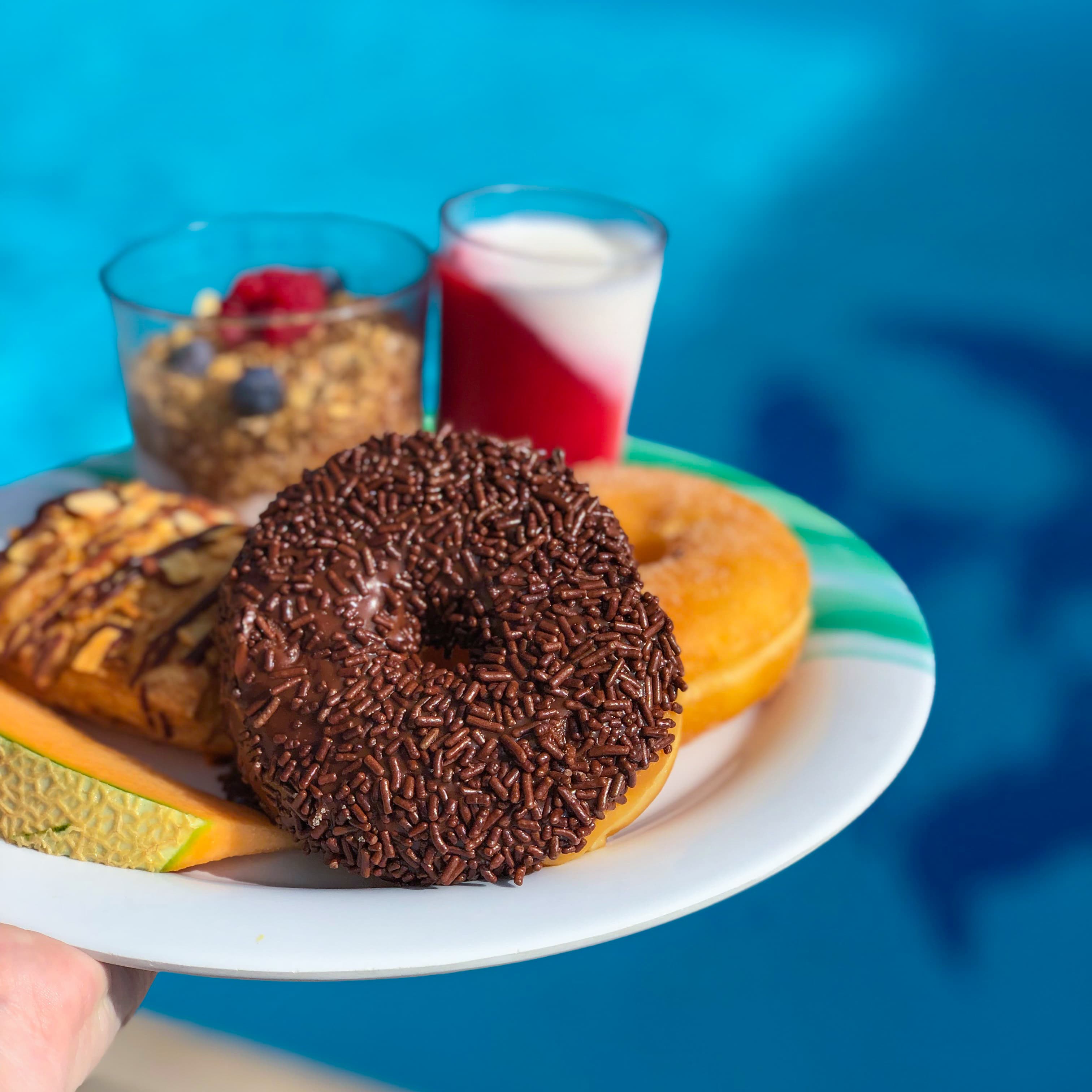 Plate with assorted breakfast items over a pool