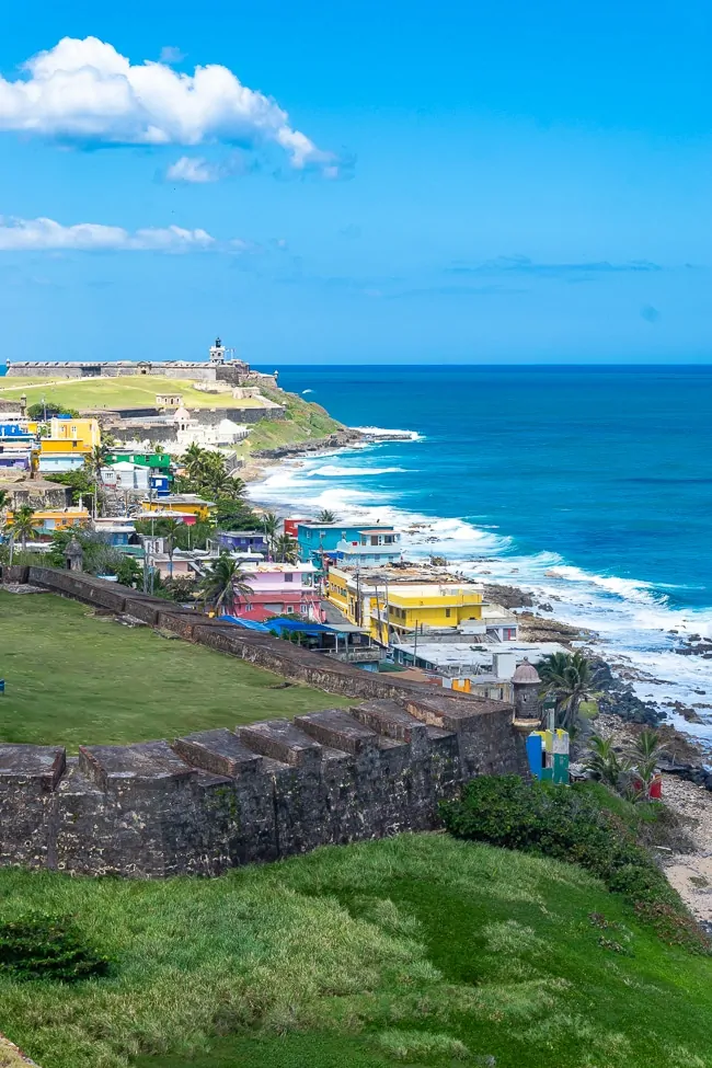 View of mountain side, colorful houses and ocean in Puerto Rico