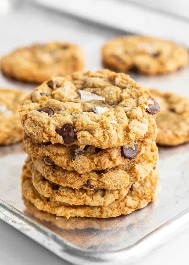 stack of crispy chocolate chip cookies on a cookie sheet 