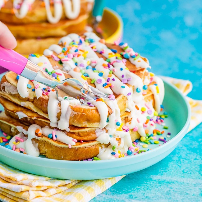 Funfetti French Toast with sprinkles and frosting on a blue plate and blue background