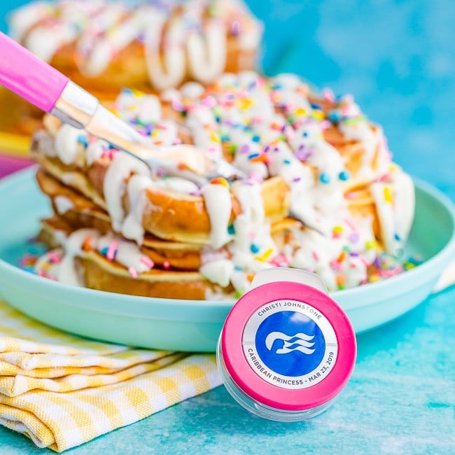 Easy French Toast with frosting and sprinkles, on a blue background, with a Princess Cruises Ocean Medallion in front of the plate