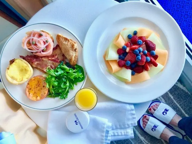 A variety of breakfast foods including melon, eggs, greens and pastries on a Princess Cruise