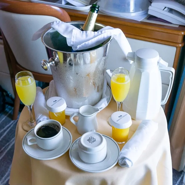 Orange juice, champagne and coffee on a table for a balcony breakfast on a Princess Cruise