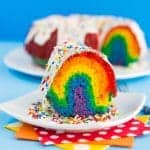 A slice of rainbow bundt cake on a white plate