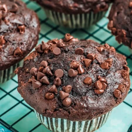 Chocolate banana muffins on a wire cooling rack.