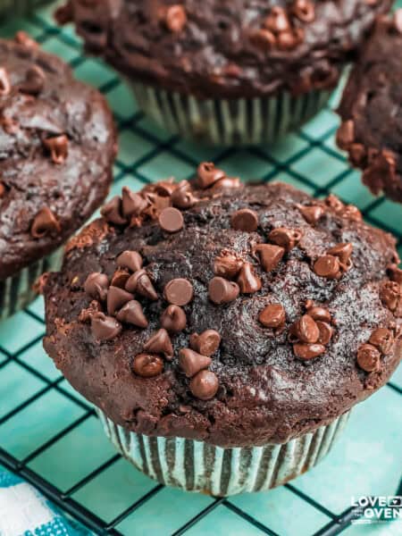 Chocolate banana muffins on a wire cooling rack.