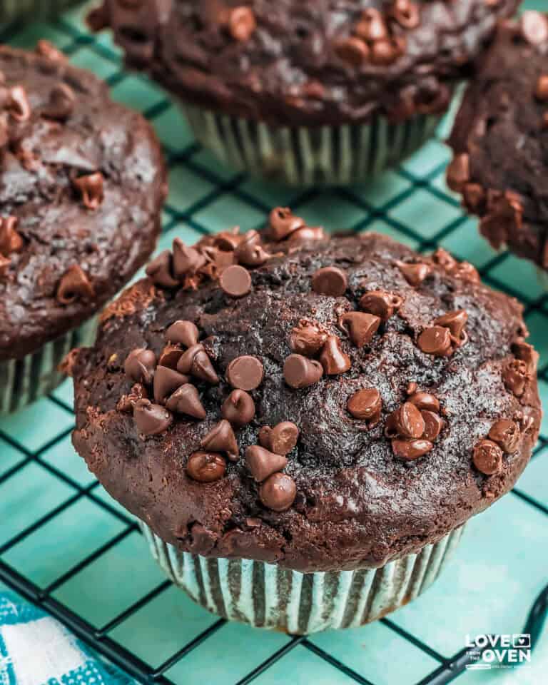 Chocolate banana muffins on a wire cooling rack.