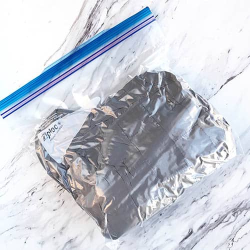 Lightweight Patagonia Nano Puff jacket folded up and put into a plastic ziplock bag
