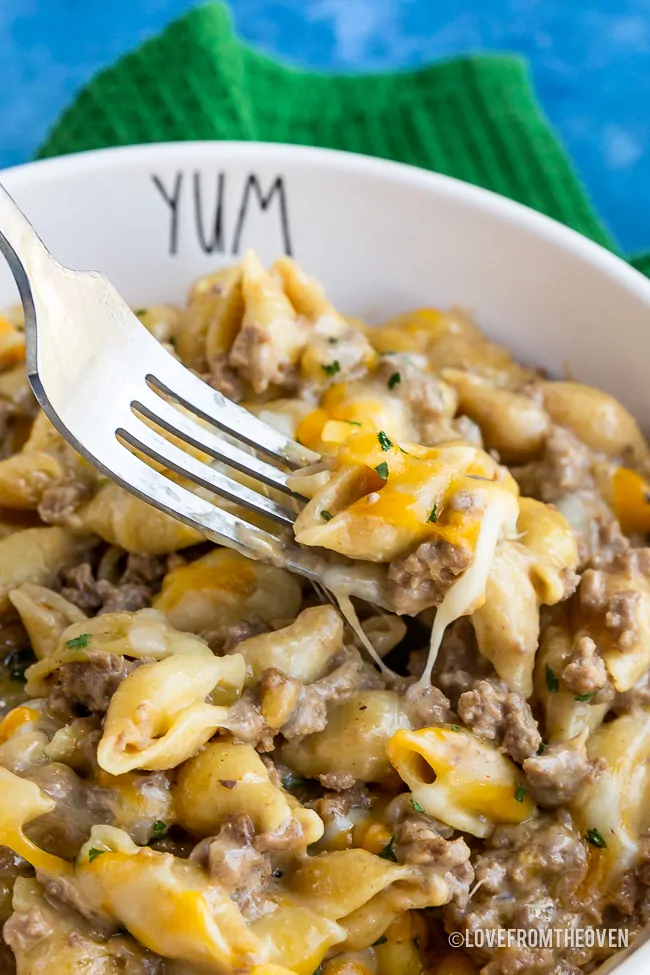 Bowl full of cheeseburger macaroni with a fork grabbing a bite of food