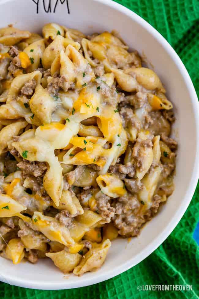 Bowl of cheeseburger macaroni sitting on a green napkin 