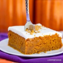 A pumpkin bar on a plate with a fork in it.