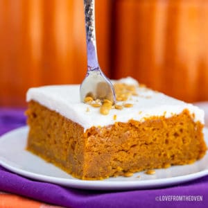 A pumpkin bar on a plate with a fork in it.