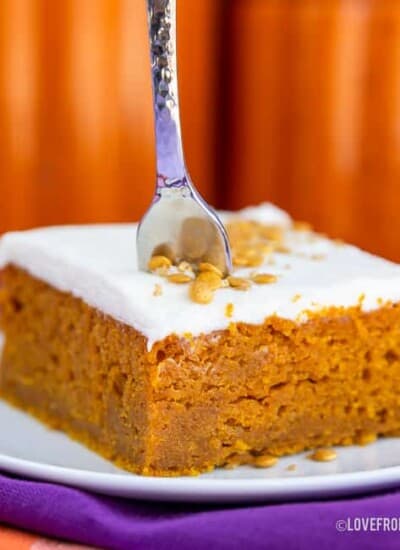 A pumpkin bar on a plate with a fork in it.