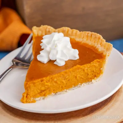 A close up of a slice of pumpkin pie