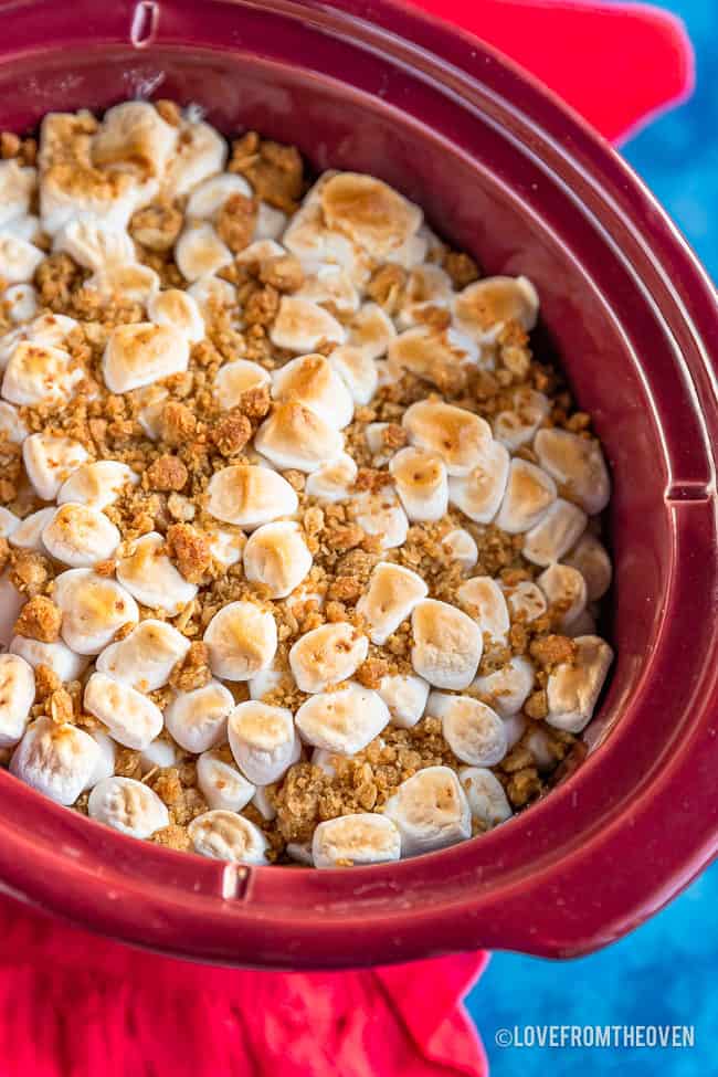 A crock pot full of sweet potato casserole