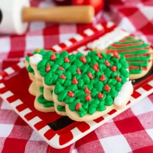 Frosted sugar cookies on a red and white plate