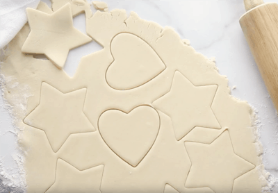 Sugar cookie dough with various shapes cut out